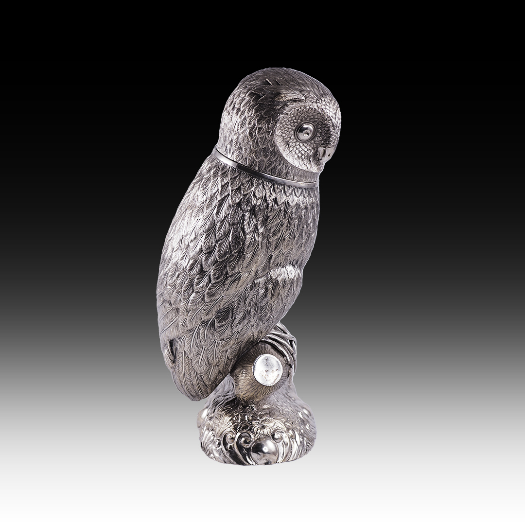 A silver drinking vessel in the shape of an owl