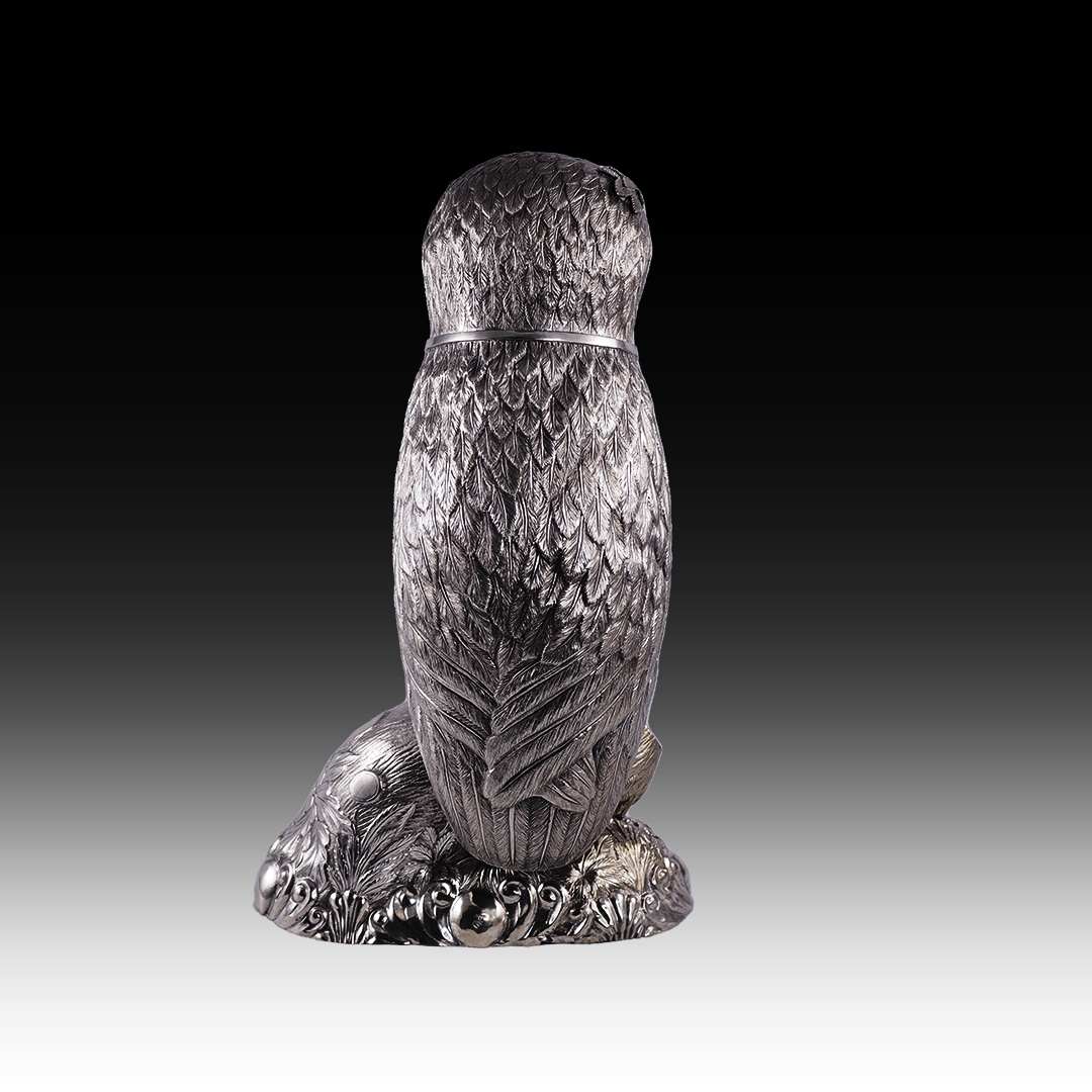 A silver drinking vessel in the shape of an owl