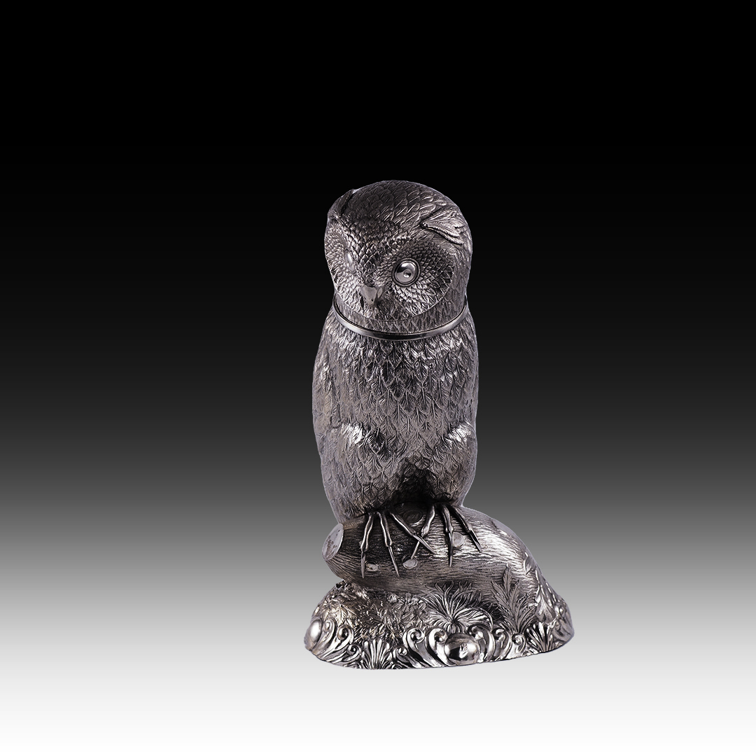 A silver drinking vessel in the shape of an owl