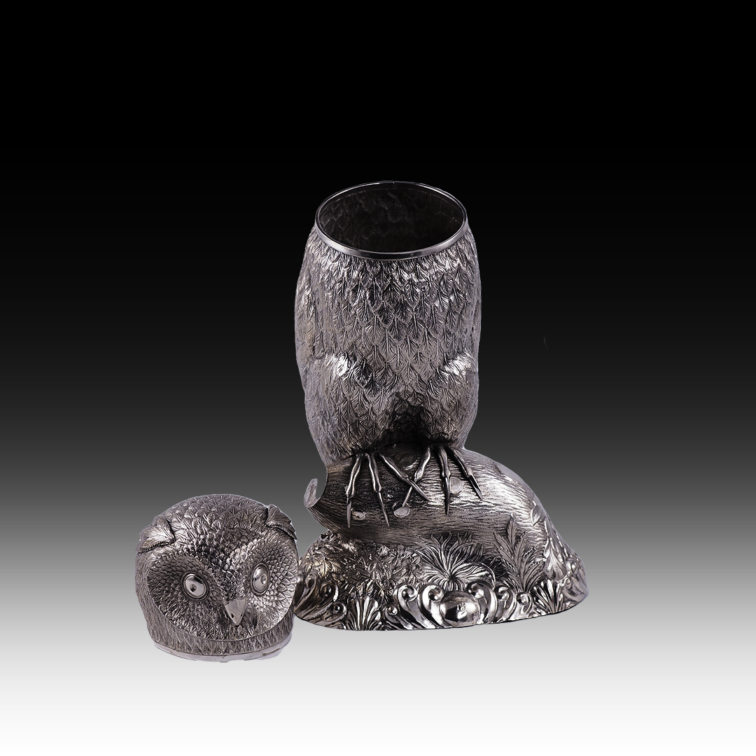 A silver drinking vessel in the shape of an owl